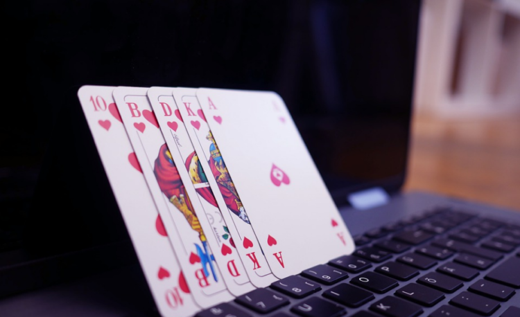 poker cards and a laptop